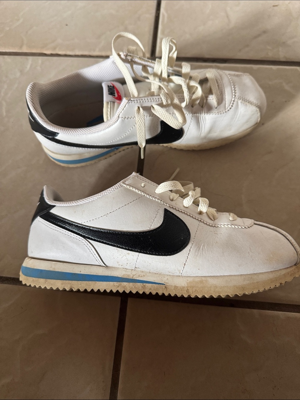 Nike White Leather Kids' Sneaker with Black Swoosh and Blue Accent